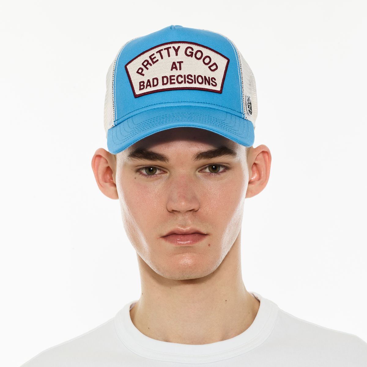 CULT "GOOD AT BAD DECISIONS" LOGO MESH BACK TRUCKER HAT (RHUBARB)